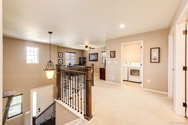 30 S Ider Way, Aurora, CO 80018 - hall with washing machine and dryer, an upstairs landing, and light carpet