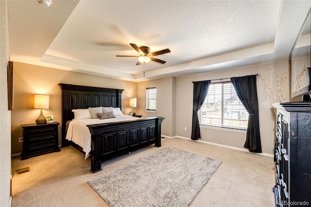 30 S Ider Way, Aurora, CO 80018 - bedroom featuring a raised ceiling, light colored carpet, a textured ceiling, and ceiling fan