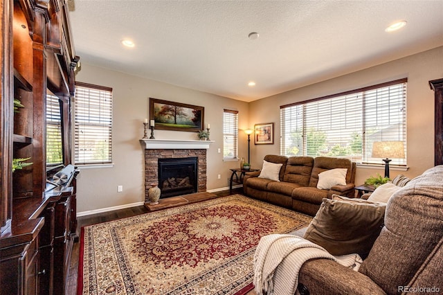 30 S Ider Way, Aurora, CO 80018 - living room featuring dark wood finished floors, a stone fireplace, and recessed lighting