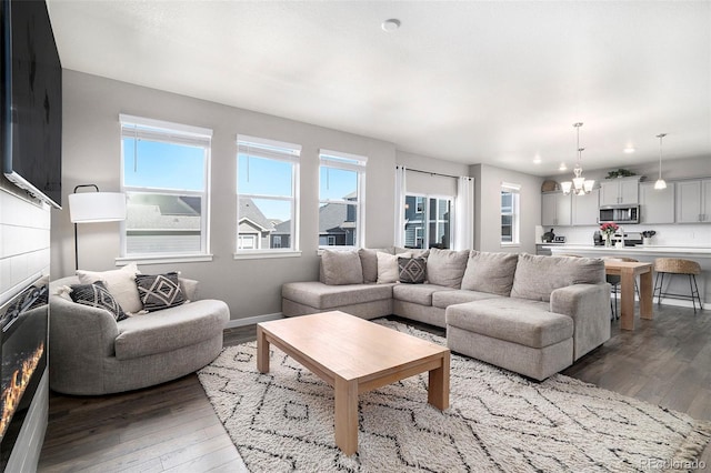 living room with a notable chandelier and dark hardwood / wood-style floors