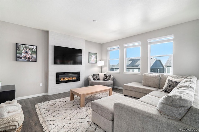 living room featuring dark hardwood / wood-style floors and a large fireplace