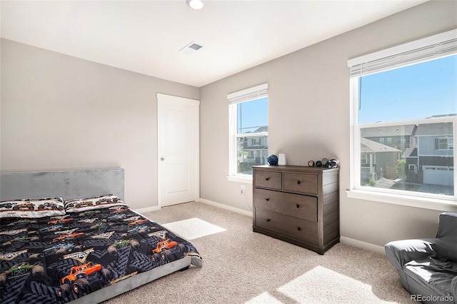 bedroom with light colored carpet