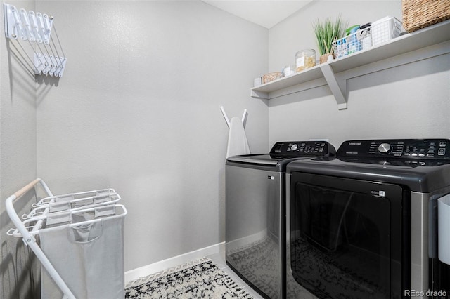 laundry area with washer and clothes dryer and tile patterned flooring