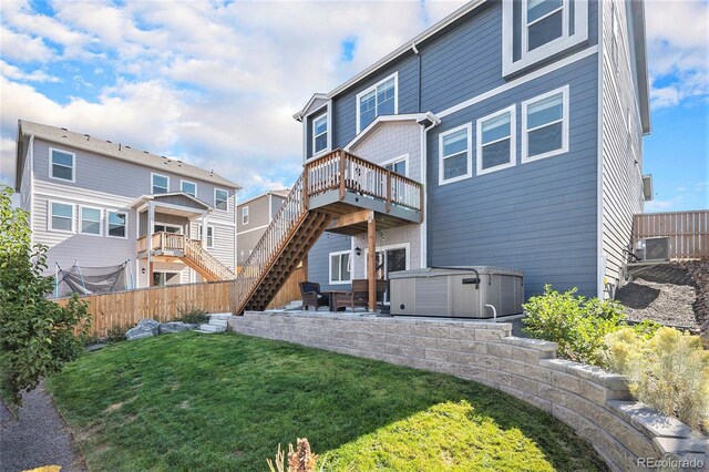 17415 Trefoil Ln, Parker, CO 80134 - rear view of house with stairs, a fenced backyard, a yard, a wooden deck, and a hot tub