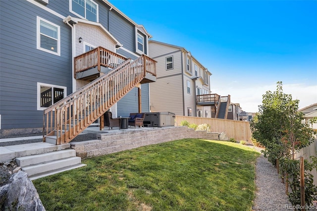 exterior space with a patio, a hot tub, a yard, and a wooden deck