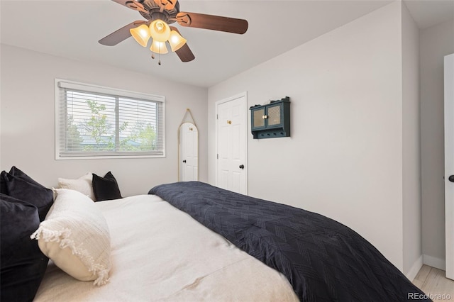 3379 W Wagon Trail Dr, Englewood, CO 80110 - bedroom featuring baseboards, ceiling fan, and light wood-style flooring