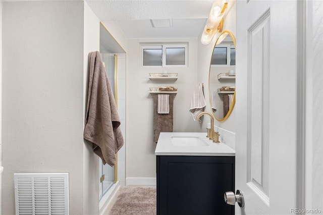 3379 W Wagon Trail Dr, Englewood, CO 80110 - full bath featuring a stall shower, vanity, a textured ceiling, and baseboards