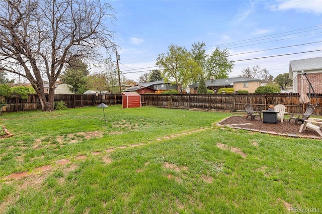 3379 W Wagon Trail Dr, Englewood, CO 80110 - view of yard with an outdoor fire pit, a storage shed, and an outdoor structure