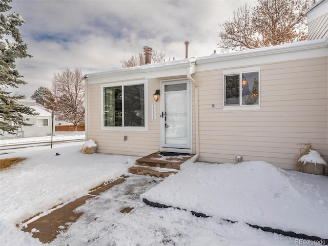 view of snow covered property entrance