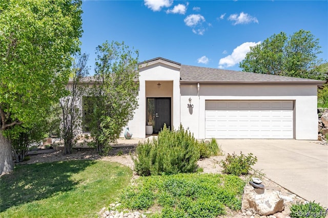 330 Ptarmigan St, Golden, CO 80403 - ranch-style home featuring concrete driveway, stucco siding, an attached garage, and a shingled roof