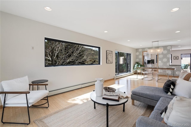 330 Ptarmigan St, Golden, CO 80403 - living room featuring a baseboard heating unit, light wood-style floors, a chandelier, recessed lighting, and baseboards