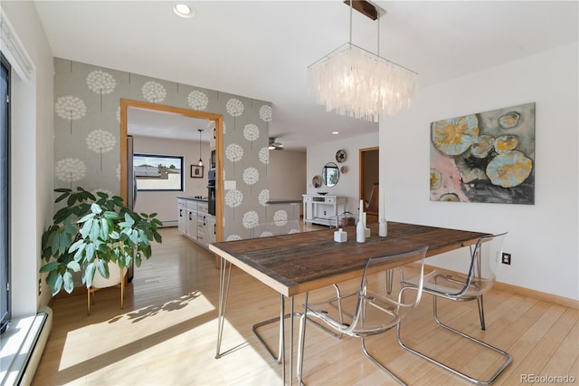 330 Ptarmigan St, Golden, CO 80403 - dining space featuring wallpapered walls, wood finished floors, baseboard heating, baseboards, and a chandelier