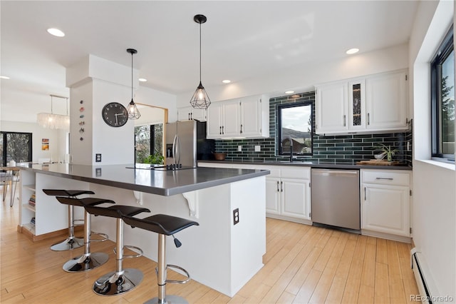 330 Ptarmigan St, Golden, CO 80403 - kitchen with appliances with stainless steel finishes, a baseboard heating unit, healthy amount of natural light, dark countertops, and recessed lighting