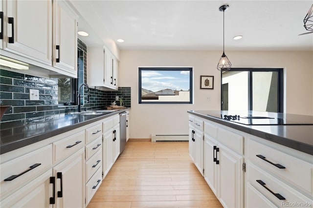 330 Ptarmigan St, Golden, CO 80403 - kitchen with black electric cooktop, a baseboard heating unit, a sink, backsplash, and dark countertops
