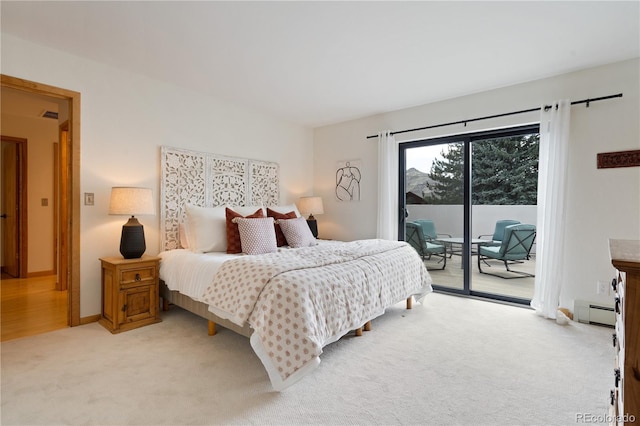 330 Ptarmigan St, Golden, CO 80403 - bedroom featuring access to outside, a baseboard heating unit, and light colored carpet