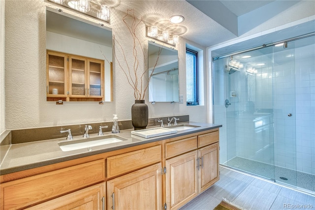 330 Ptarmigan St, Golden, CO 80403 - full bathroom with a textured wall, a shower stall, and double vanity