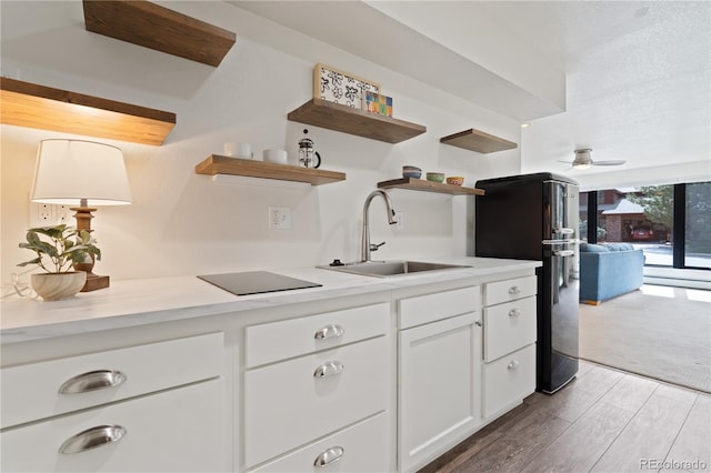 330 Ptarmigan St, Golden, CO 80403 - kitchen with a sink, open shelves, freestanding refrigerator, white cabinets, and light countertops
