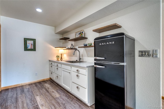330 Ptarmigan St, Golden, CO 80403 - kitchen featuring freestanding refrigerator, a sink, white cabinetry, wood finished floors, and light countertops
