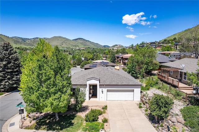 330 Ptarmigan St, Golden, CO 80403 - view of front facade with a mountain view, concrete driveway, an attached garage, and a residential view