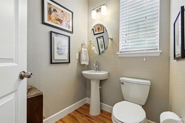 3240 Spruce St, Denver, CO 80238 - bathroom with toilet, wood finished floors, a sink, and baseboards