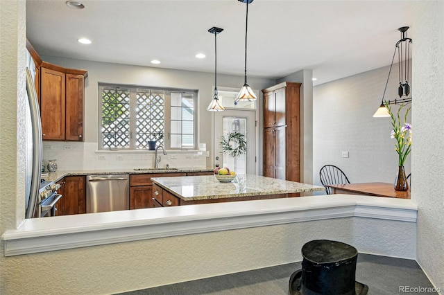 3240 Spruce St, Denver, CO 80238 - kitchen featuring appliances with stainless steel finishes, a sink, brown cabinets, recessed lighting, and pendant lighting