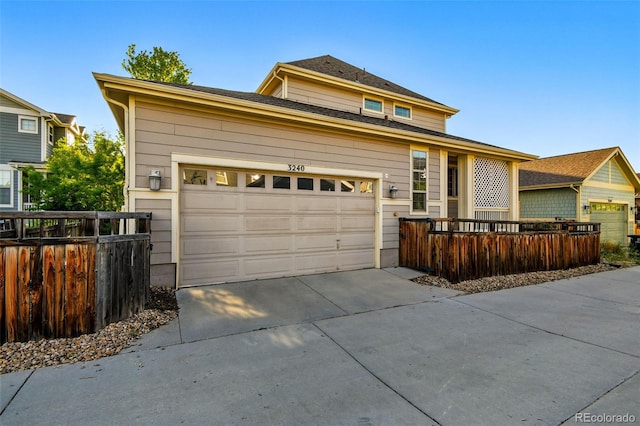 3240 Spruce St, Denver, CO 80238 - view of front facade with driveway, fence, and a garage