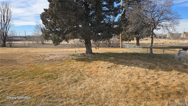 view of yard featuring a rural view and fence