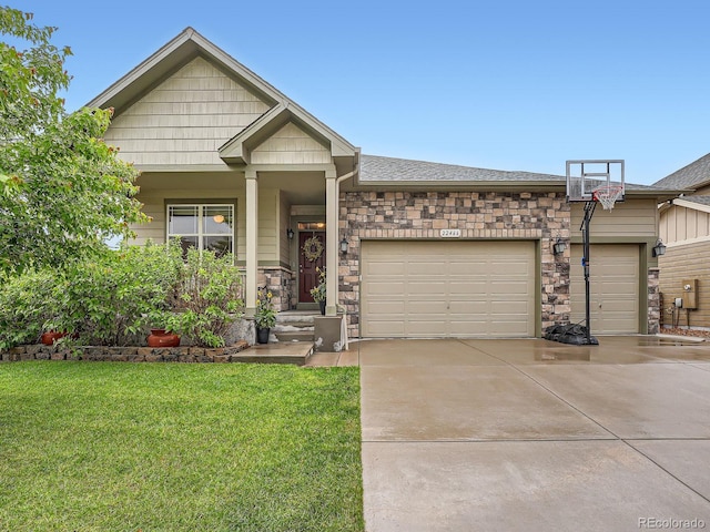 22466 E Layton Cir, Aurora, CO 80015 - craftsman-style house with a garage, stone siding, a front yard, concrete driveway, and roof with shingles