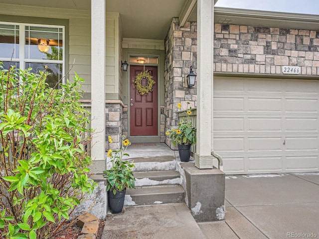22466 E Layton Cir, Aurora, CO 80015 - doorway to property featuring stone siding and a garage