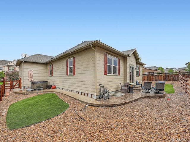 22466 E Layton Cir, Aurora, CO 80015 - view of home's exterior with a hot tub, a patio, and a fenced backyard