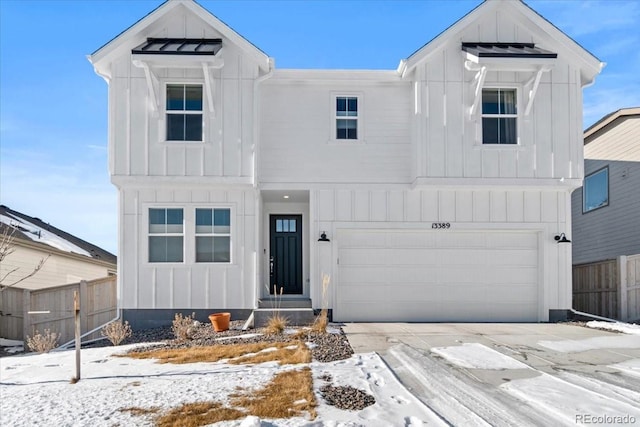 modern farmhouse style home with fence, board and batten siding, and driveway