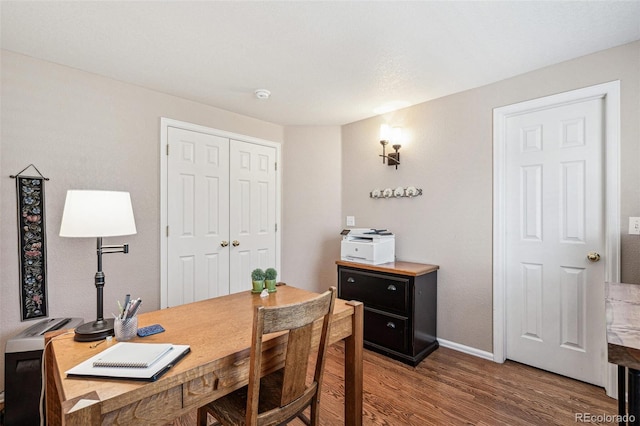 home office featuring wood finished floors and baseboards