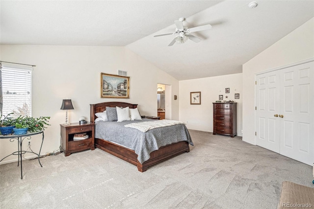 carpeted bedroom with visible vents, a ceiling fan, and lofted ceiling