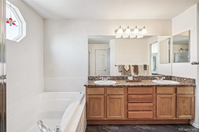 bathroom with a sink, a garden tub, and double vanity