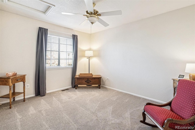 sitting room with baseboards, visible vents, carpet floors, attic access, and ceiling fan