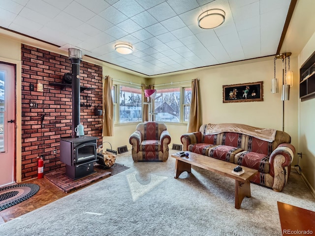 carpeted living room with a wood stove