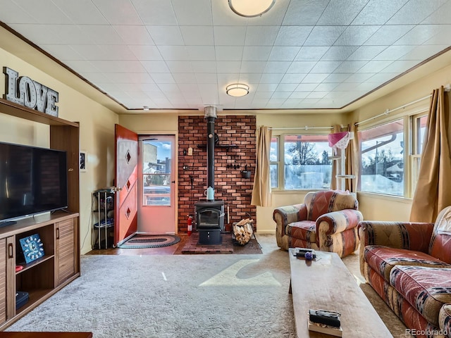 living room with carpet and a wood stove