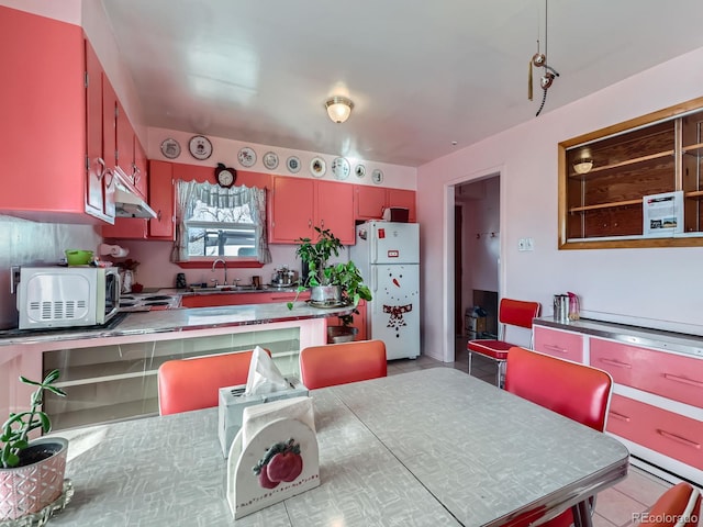 kitchen with sink, white fridge, and light tile patterned floors