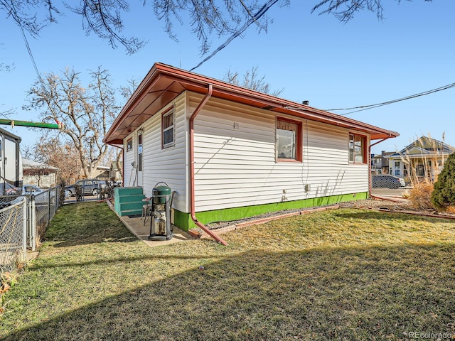 view of side of property with a yard