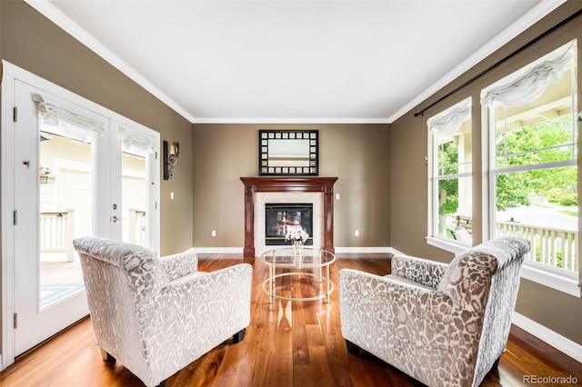 6032 Umber St, Arvada, CO 80403 - living room with wood finished floors, ornamental molding, a glass covered fireplace, and baseboards