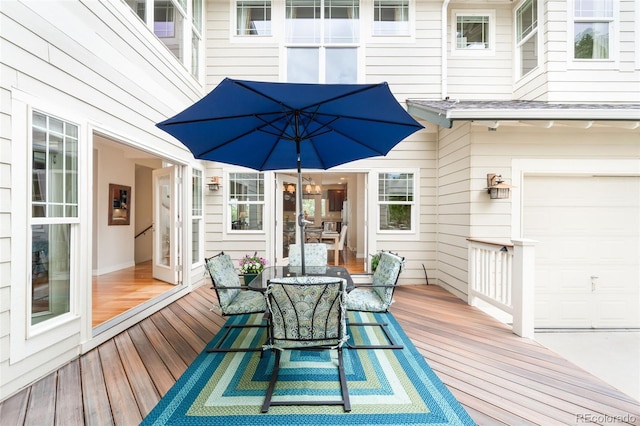 6032 Umber St, Arvada, CO 80403 - wooden terrace with an attached garage and outdoor dining space