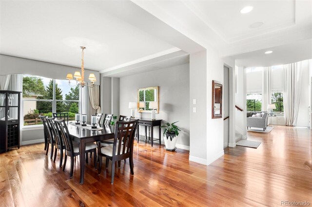 6032 Umber St, Arvada, CO 80403 - dining area with healthy amount of natural light, a chandelier, stairway, light wood-style flooring, and recessed lighting