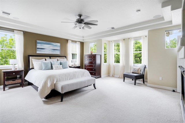 6032 Umber St, Arvada, CO 80403 - bedroom featuring a tray ceiling, light carpet, and multiple windows