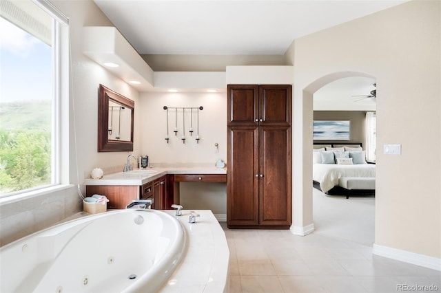 6032 Umber St, Arvada, CO 80403 - ensuite bathroom featuring a jetted tub, vanity, baseboards, tile patterned floors, and ceiling fan