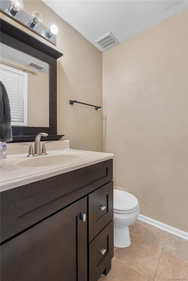 13664 Linden Ct, Thornton, CO 80602 - half bathroom featuring vanity, toilet, baseboards, and tile patterned flooring
