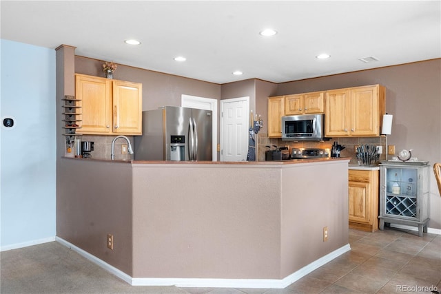 13664 Linden Ct, Thornton, CO 80602 - kitchen with appliances with stainless steel finishes, light brown cabinets, backsplash, and recessed lighting