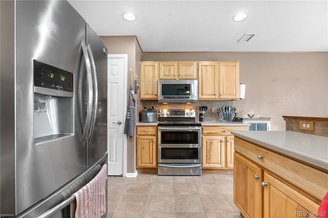13664 Linden Ct, Thornton, CO 80602 - kitchen with stainless steel appliances, light brown cabinets, light countertops, backsplash, and light tile patterned floors