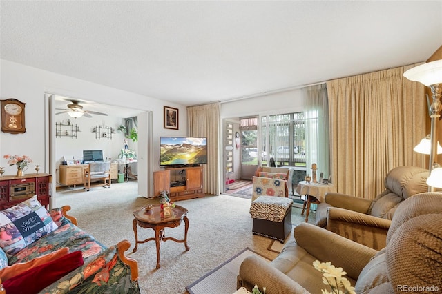 carpeted living room with ceiling fan