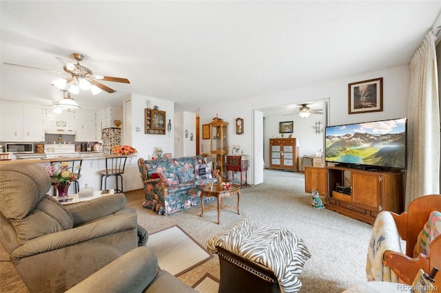 carpeted living room featuring ceiling fan