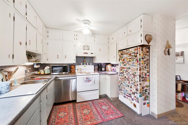 kitchen with backsplash, ceiling fan, white cabinetry, appliances with stainless steel finishes, and sink